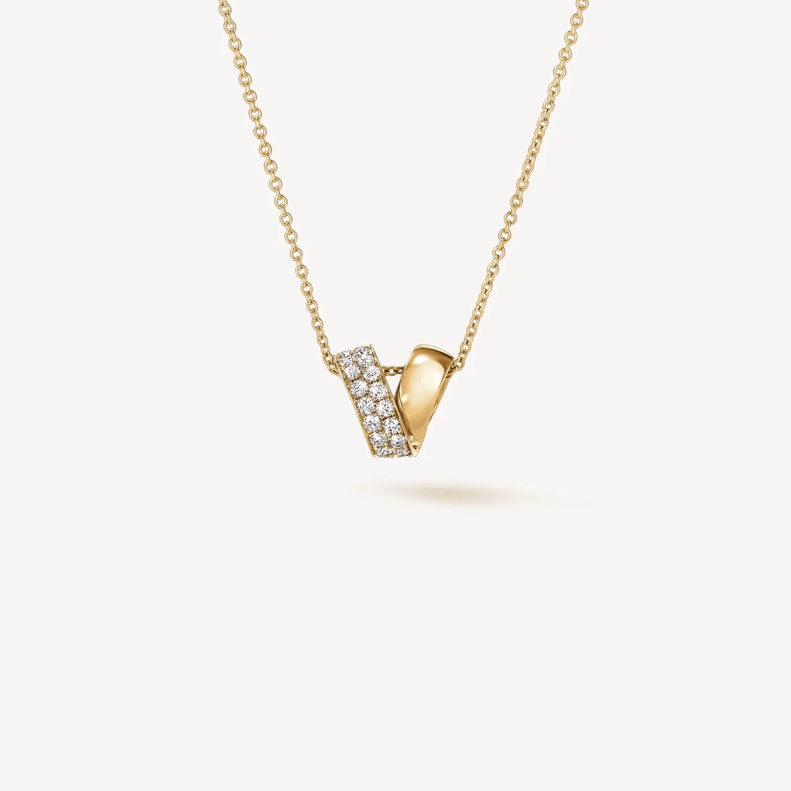 A yellow gold necklace with diamonds from designer Hearts on Fire.