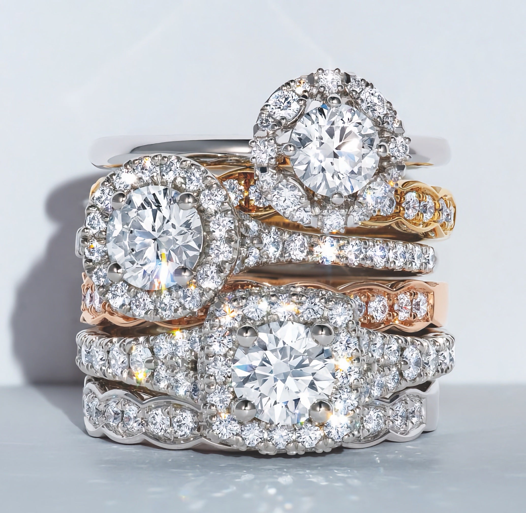 A stack of engagement rings and wedding bands.